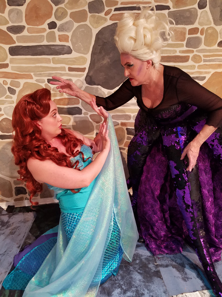Ursula (Kim Peterson), the Sea Witch, threatens Ariel (Lyndsay Palmer).